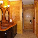 Master bath with cedar paneling milled on site with pebble tile flooring